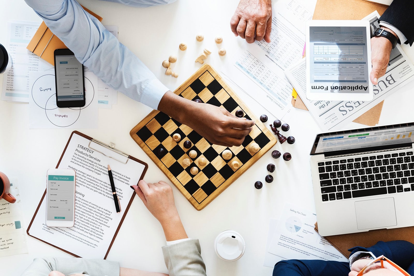 A group of individuals strategising and playing chess