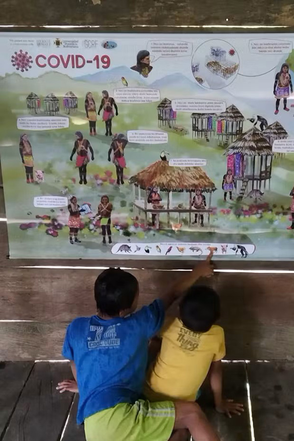 Children study a poster, looking for animals
